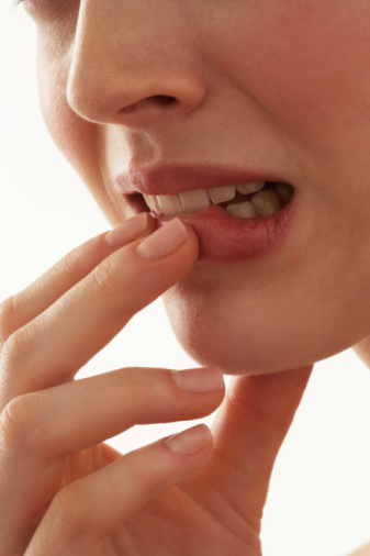 anxious biting lip(1) - Twelve relationship stress factors that bring on dermatitis
