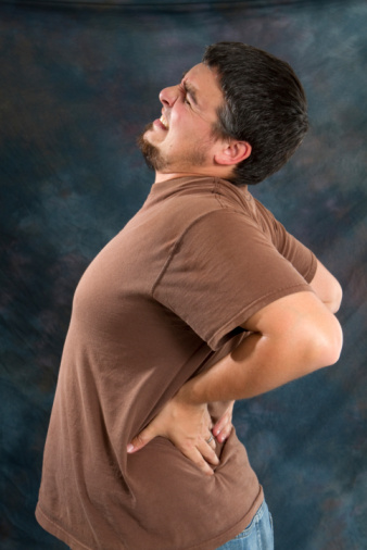 backache man - Ease low back pain with forgiveness rather than anger